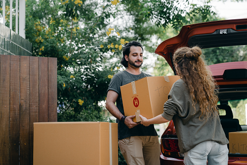 A young couple moving boxes.