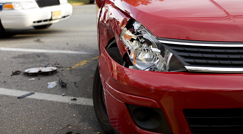 A red car with accident damage.