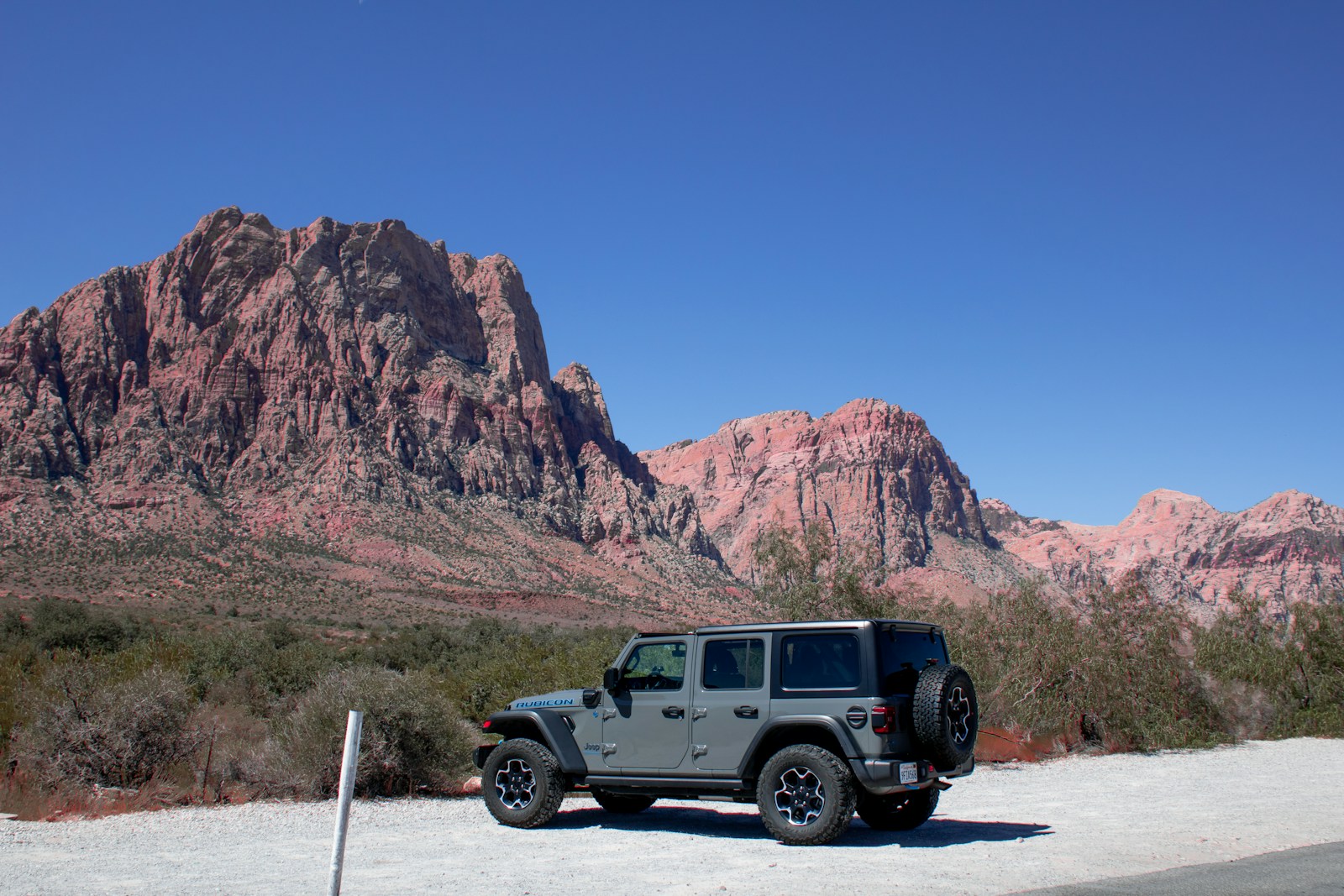 A jeep parked in front of a mountain range